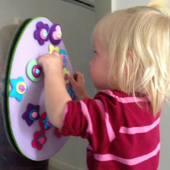 Cassie (16months) decorating the felt Easter egg while big sisters are away