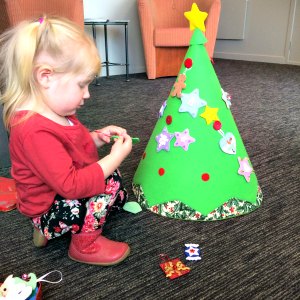 Cassie decorating her felt Christmas tree