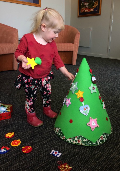 Cassie decorating her felt Christmas tree