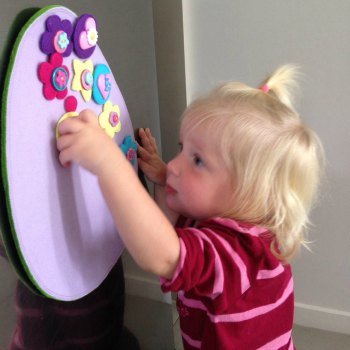 Cassie (16months) decorating the felt Easter egg while big sisters are away