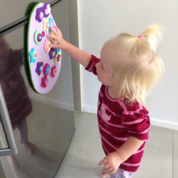 Cassie (16months) decorating the felt Easter egg while big sisters are away