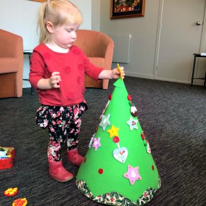 Cassie decorating her felt Christmas tree